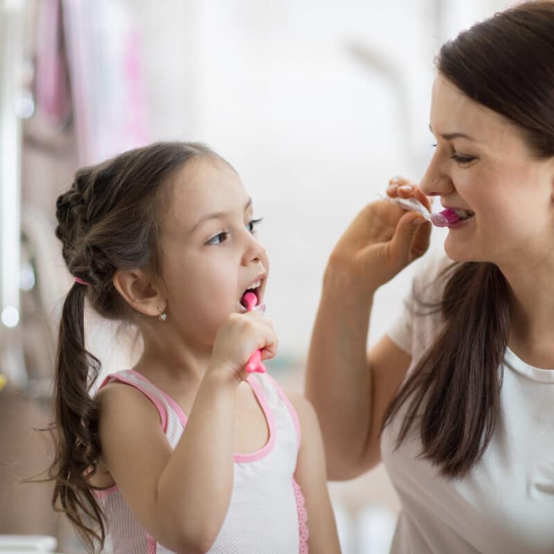 Mother,Teaching,Kid,Daughter,Teeth,Brushing,In,Bathroom