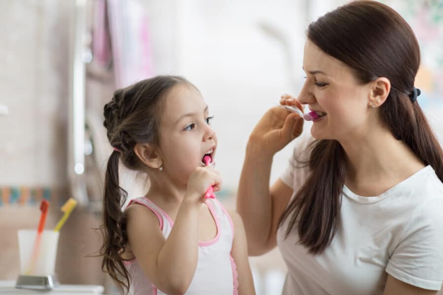 Mother,Teaching,Kid,Daughter,Teeth,Brushing,In,Bathroom